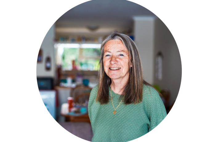 Woman in home looking into camera