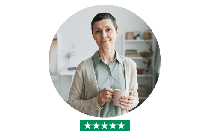 Middle age woman in home with a cup in head, looking into the camera - five star rating