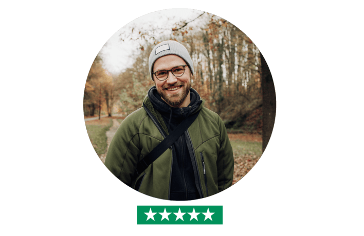 Young man standing outside looking into camera - five star rating
