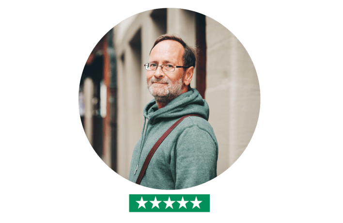 Middle aged man looking in camera outdoors - five star rating